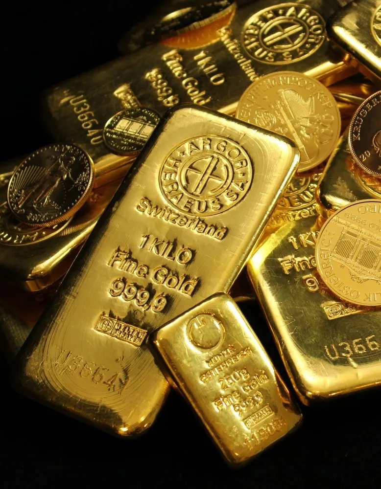 Gold bullion bars stacked with gold coins
