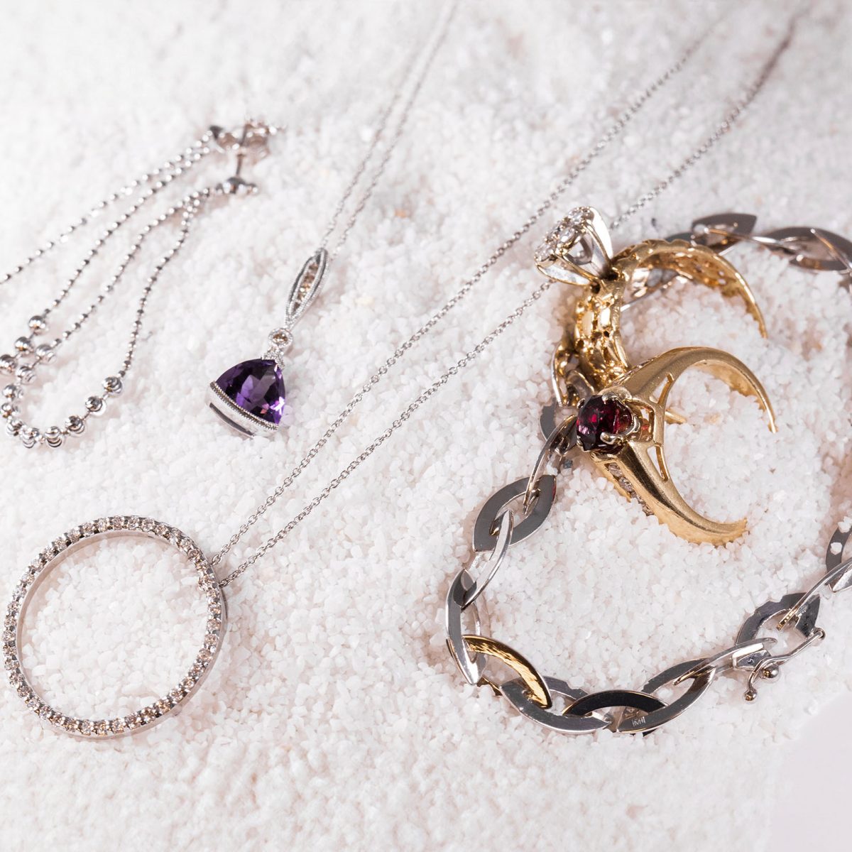 Gold and silver rings, a diamond necklace, and a gemstone pendant