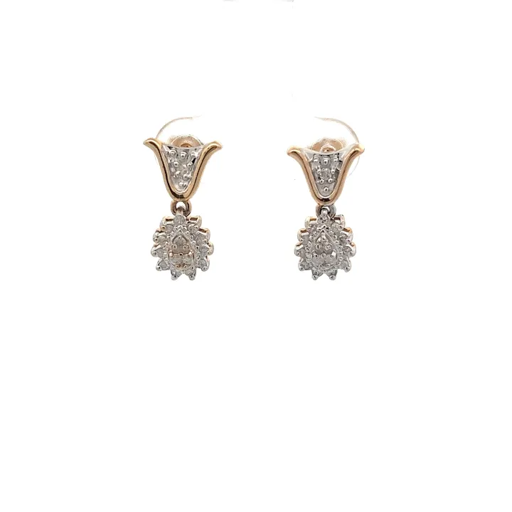 Pair of gold dangle earrings each with a round cluster of small pave diamonds, on a white background