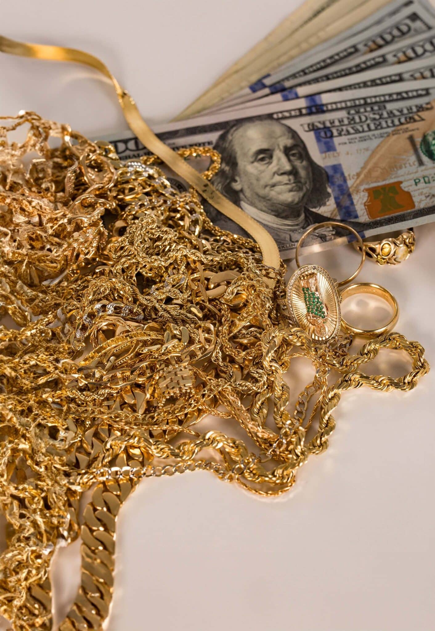 Gold jewelry and cash for precious metals investment.