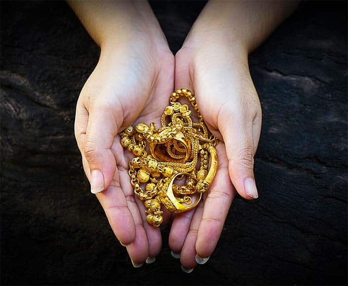 Gold jewelry being evaluated at Accurate Precious Metals