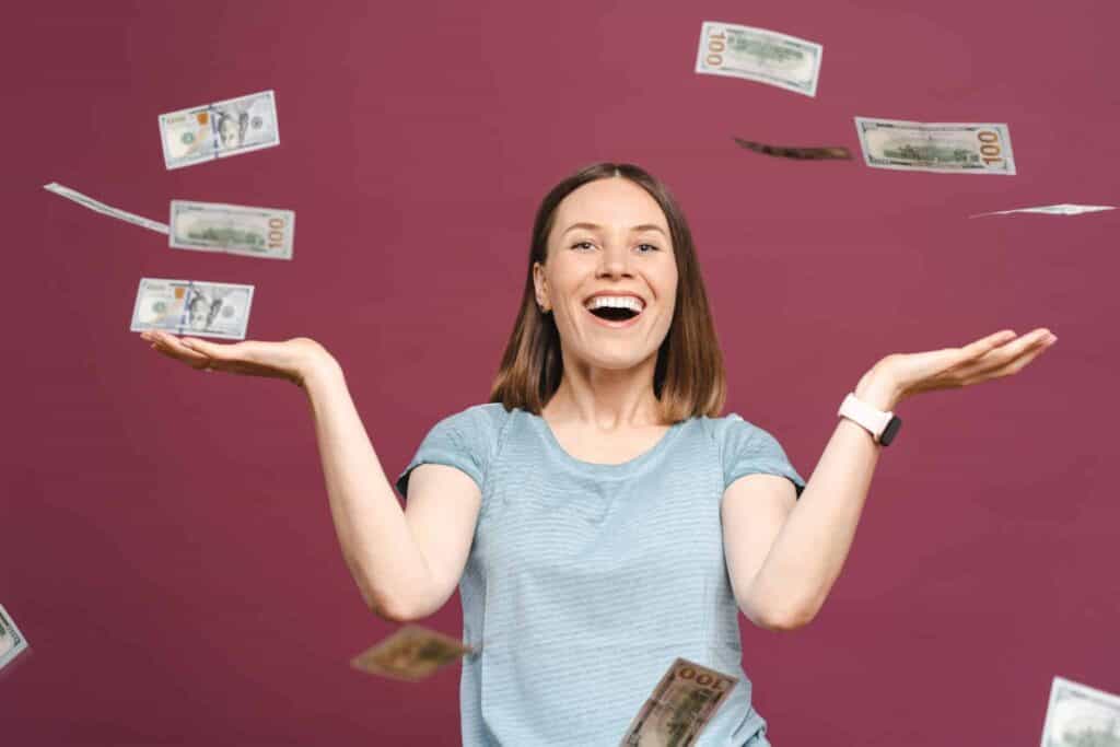 Woman with cash falling, representing precious metals investment and wealth.