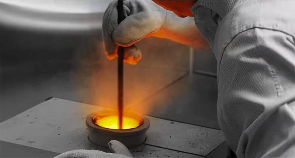 Gold or silver being melted in a crucible for precious metal refining.