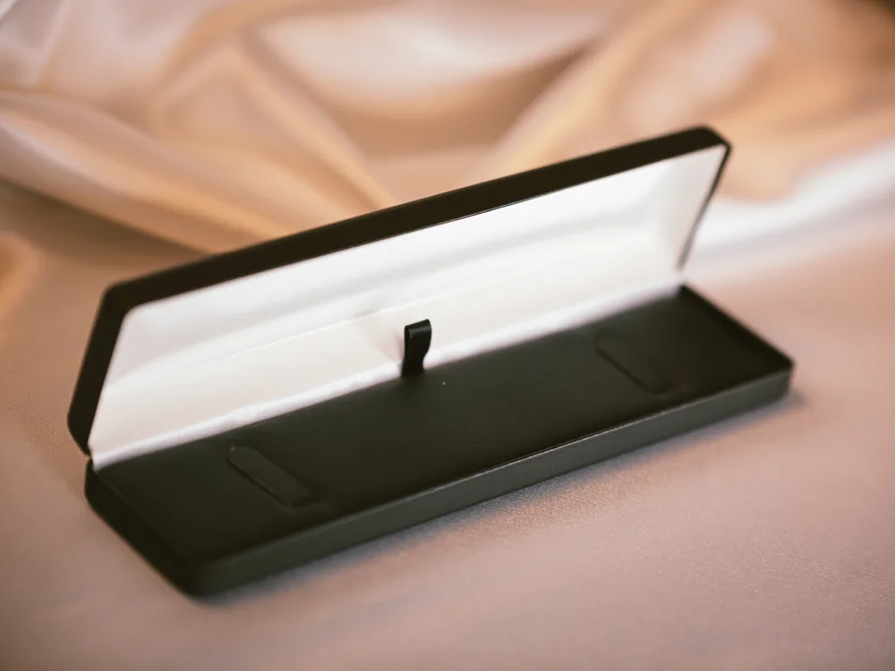 Open black jewelry box ready to be packed