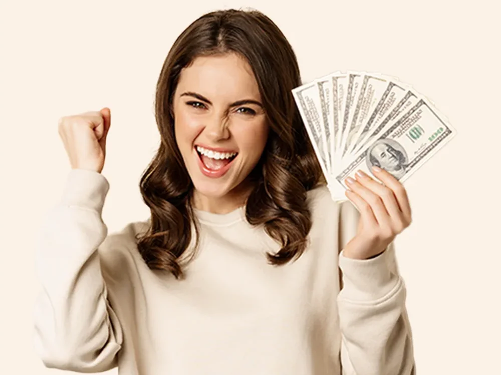 Smiling woman holding a fan of cash
