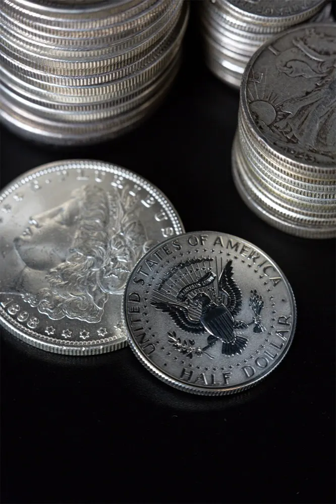 Stacks of 90 percent silver half dollars and a Morgan silver dollar