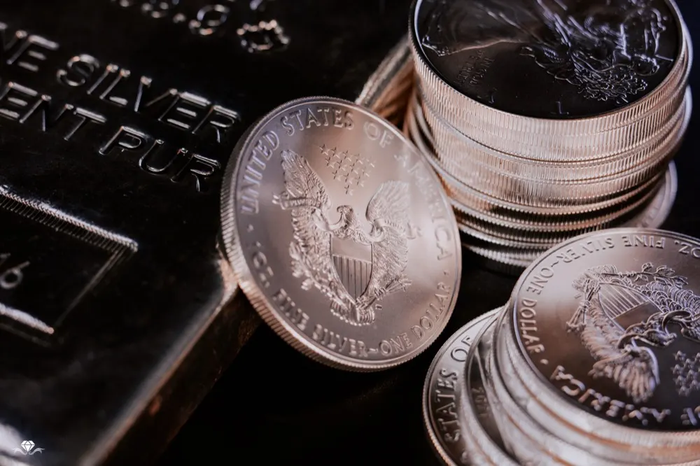 American Silver Eagle coins stacked beside a silver bar