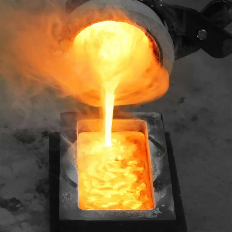 Gold being poured from furnace into mold during precious metals refining.