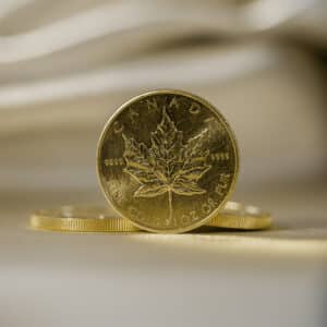 A 1 oz Gold Maple Leaf on a white background.