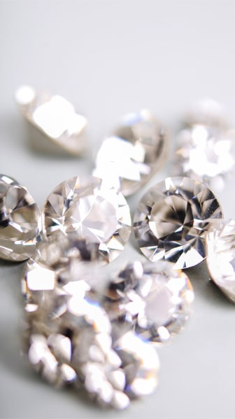 Stunning image of a grouping of diamonds, highlighting the beauty and value of these precious gems. Invest in diamonds today for a secure and potentially lucrative investment option. Our trusted services ensure a seamless and reliable transaction process.
