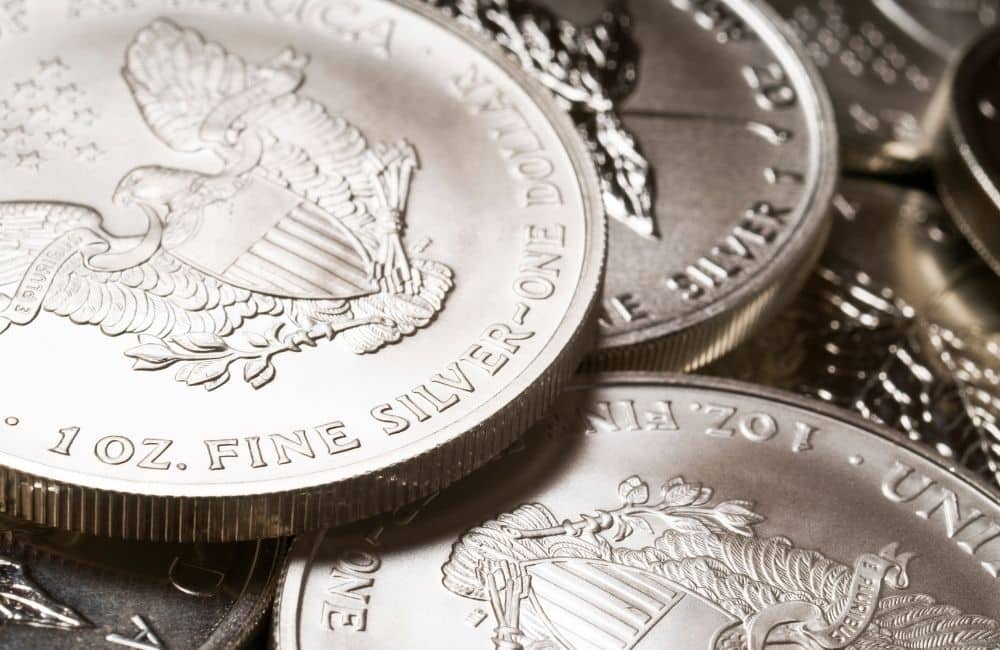 Silver eagle coins are stacked on top of each other.