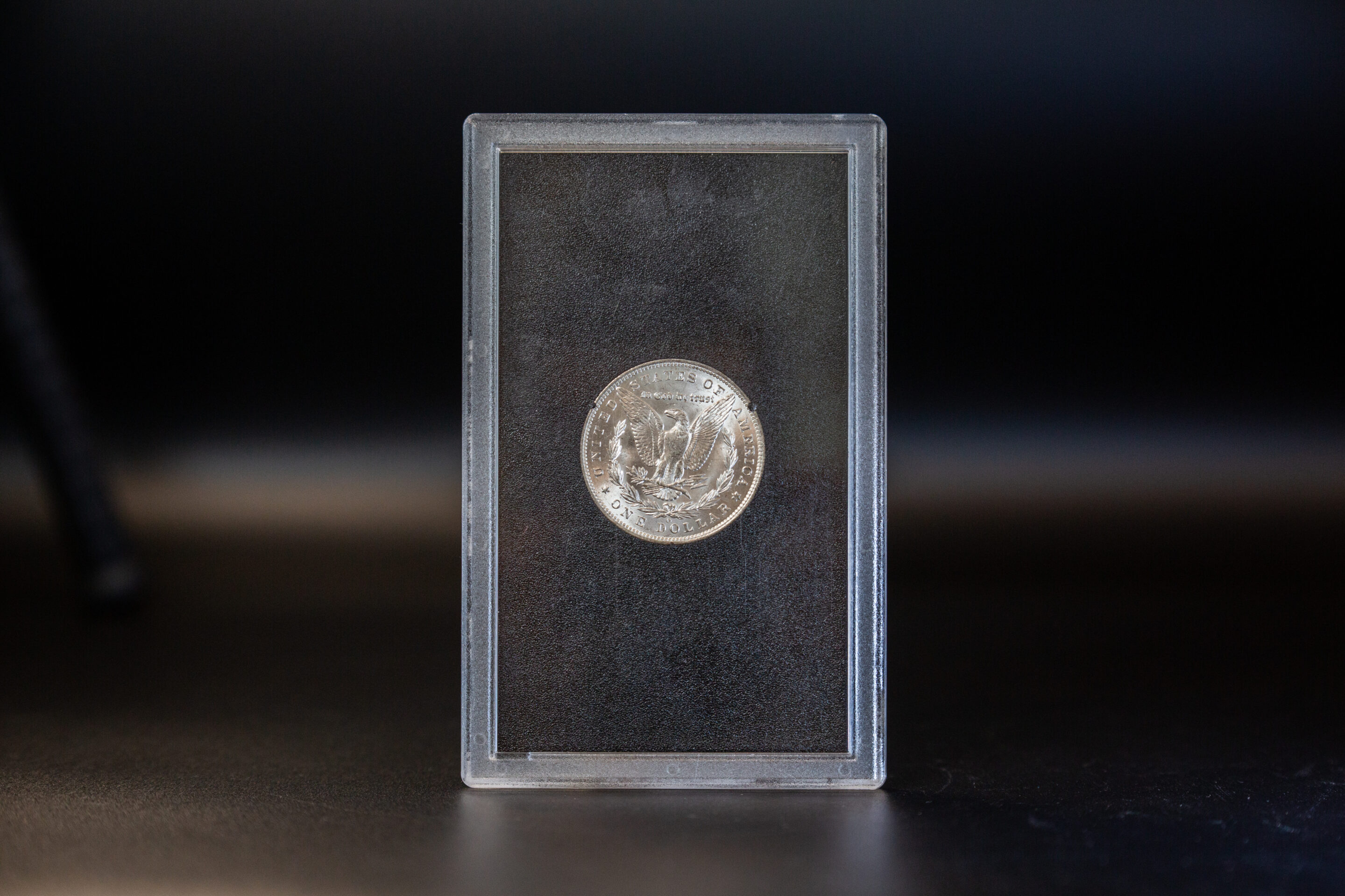 A silver coin packaged in a clear plastic case.