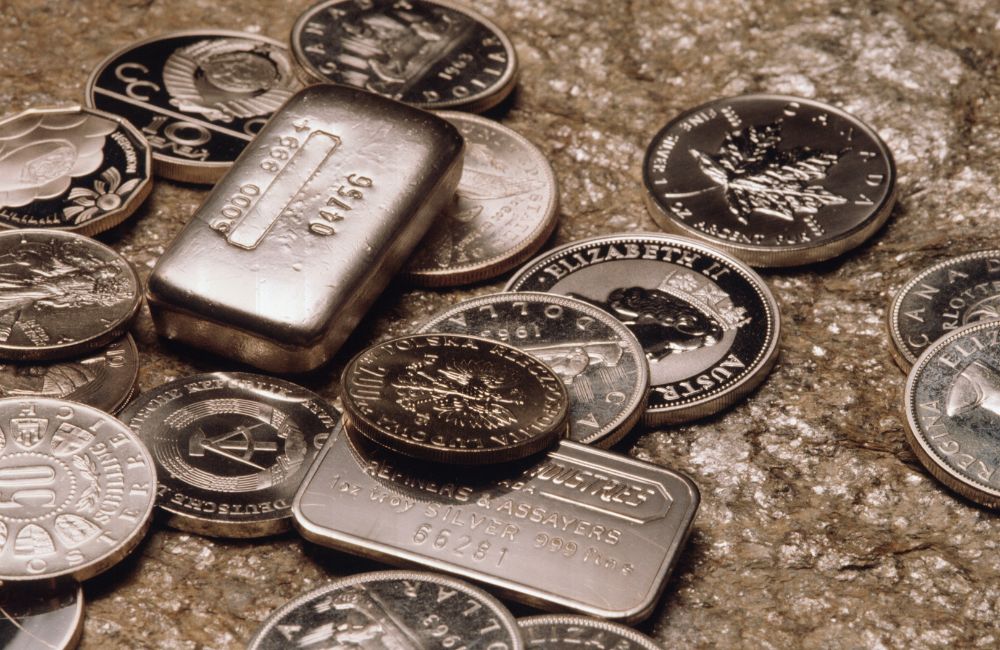 Image of a variety of gold and silver bullion bars and coins, enticing viewers to shop online for precious metals.
