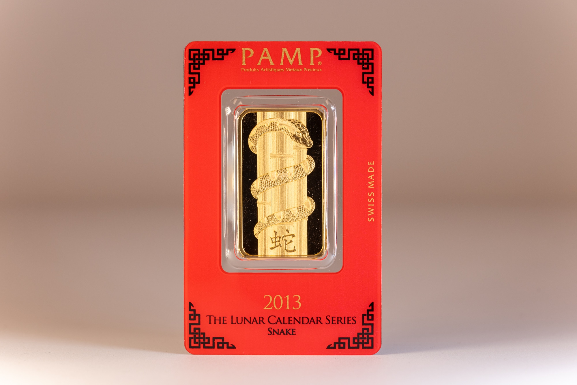 A gold bar in a box on a white background featuring the Snake from the Lunar Calendar Series.