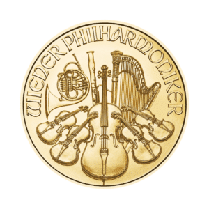 A gold coin featuring an engraved design of various orchestral instruments and the text "austrian philharmonic gold coin.