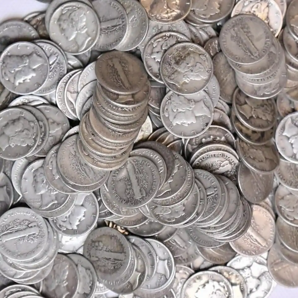 Pile of Mercury Dimes coins from various years and mints.