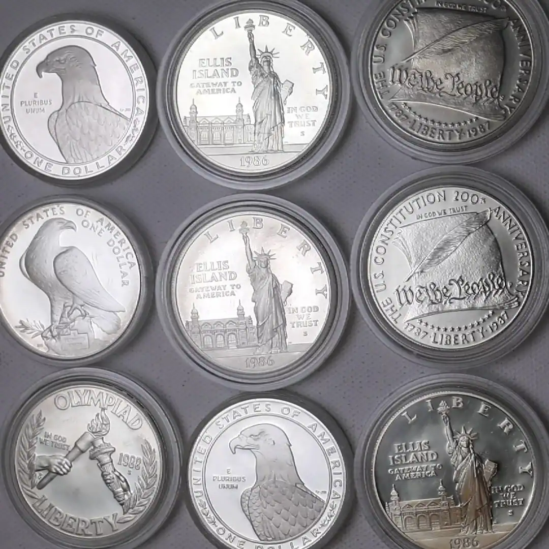 Collection of silver coins featuring iconic American symbols and historical figures.